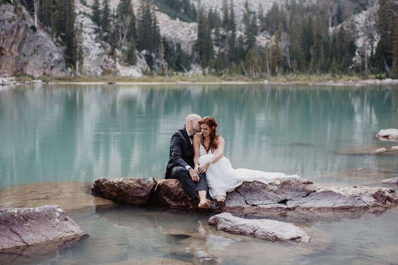 outdoor weddin gpictures on a bright blue lake captured by jackson hole photographers at Delta Lake for a true adventure wyoming elopement
