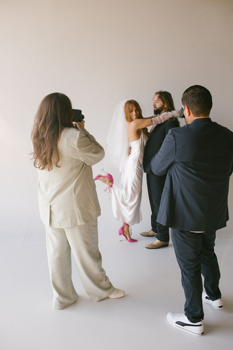The bride and groom smile warmly in a studio setting, capturing the essence of their wedding celebration.