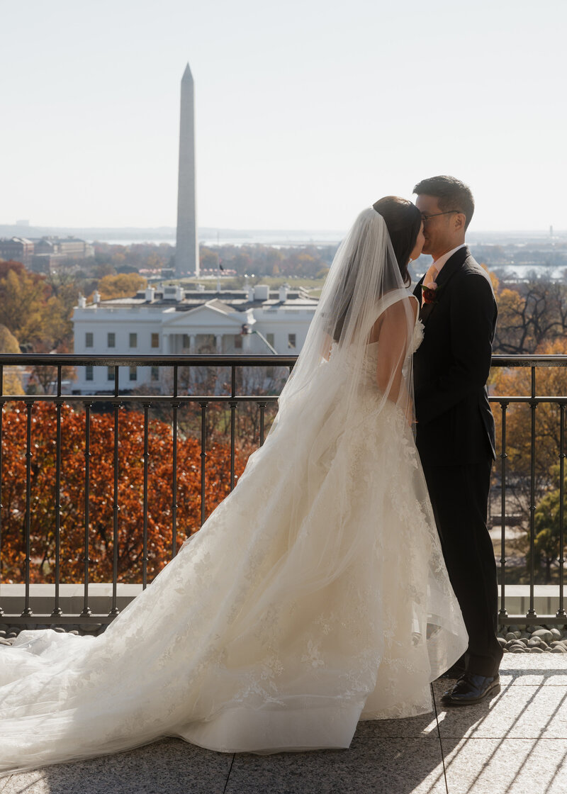 bride and groom kiss at a Catholic wedding planned by Boizelle Affaires
