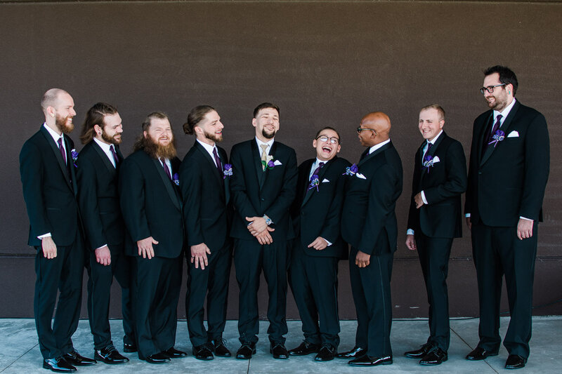 groomsmen-taking-photo-as-they-laugh-with-each-other