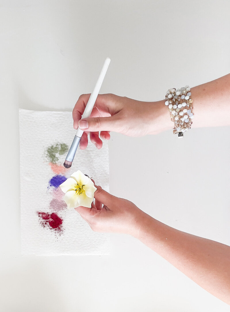 woman painting sugar flower