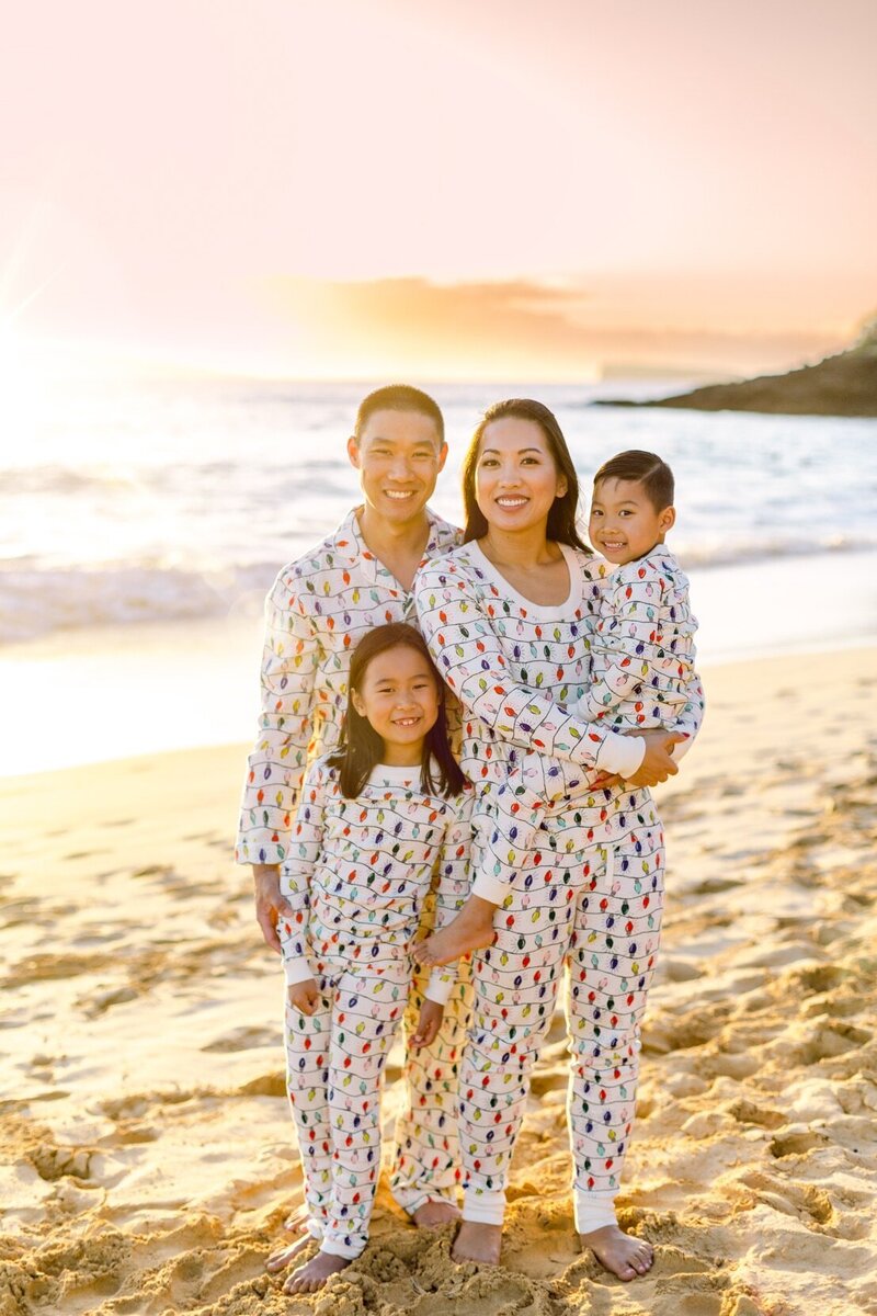 Sunset beach Christmas family photo with Christmas pajamas on Maui