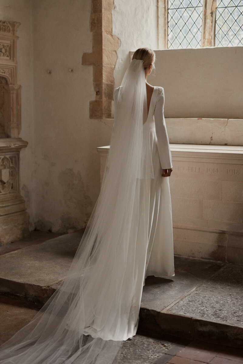 Deep v back silk wedding dress on natural bride in church