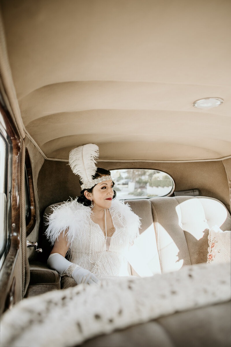 Bride travelling in vintage car to Sepulveda Home