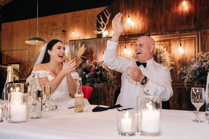 bride and groom laugh during wedding reception at bangor farm in darfield with wooden panel walls