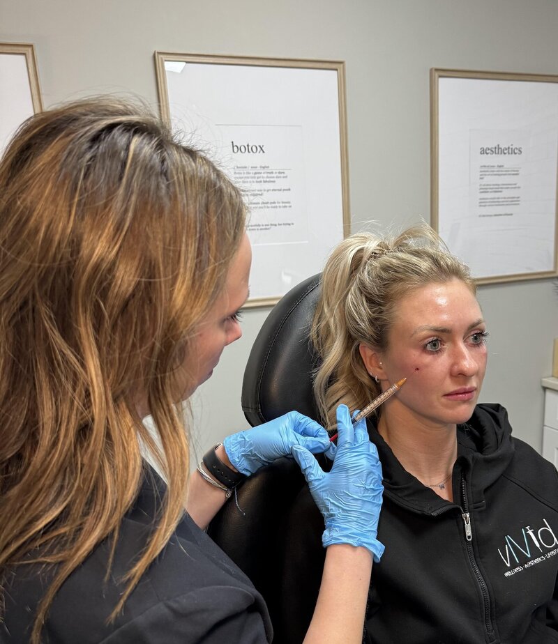 Woman getting a lip filler injection