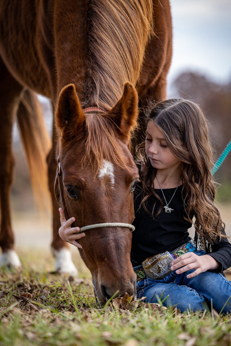 Chestnut horse and young girl