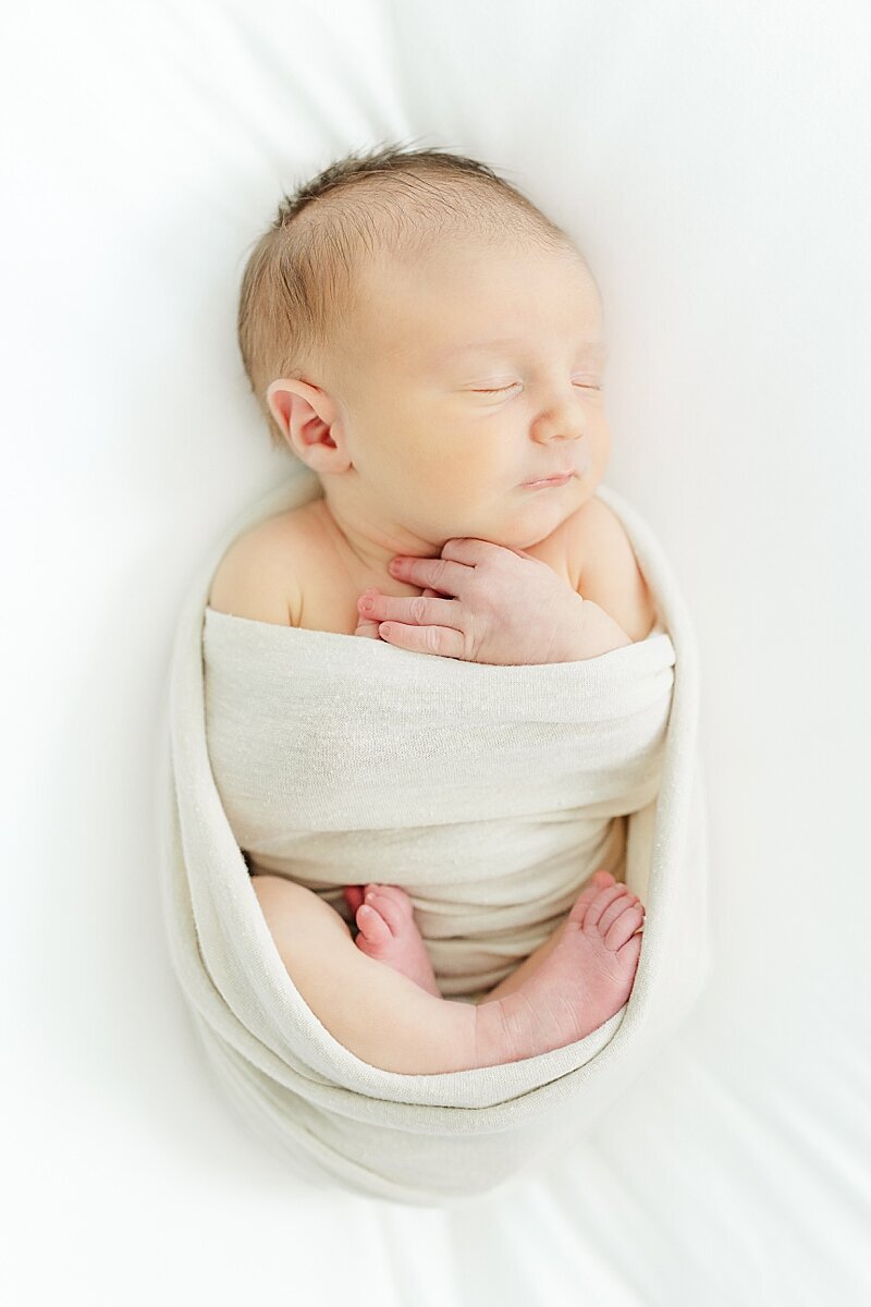 baby boy swaddled newborn photo