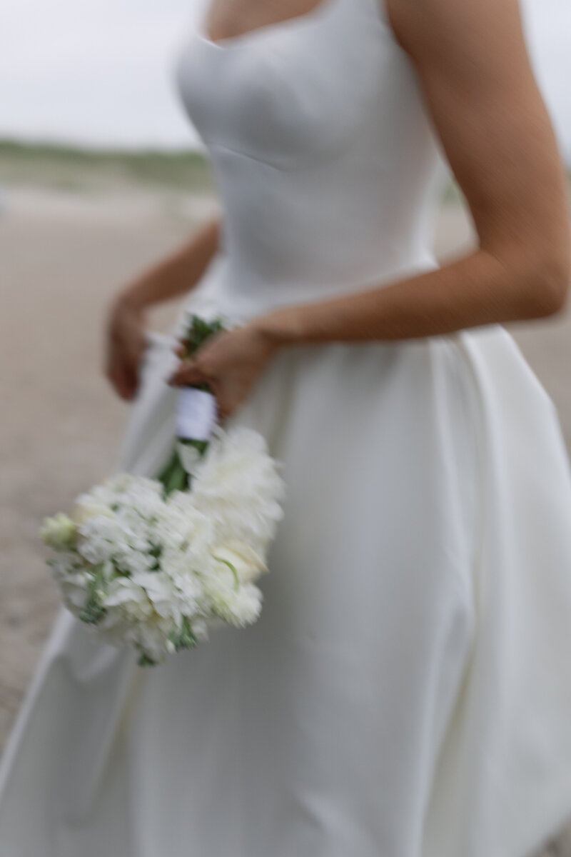 Candid bride and groom laughter during golden hour at Beaufort waterfront wedding.