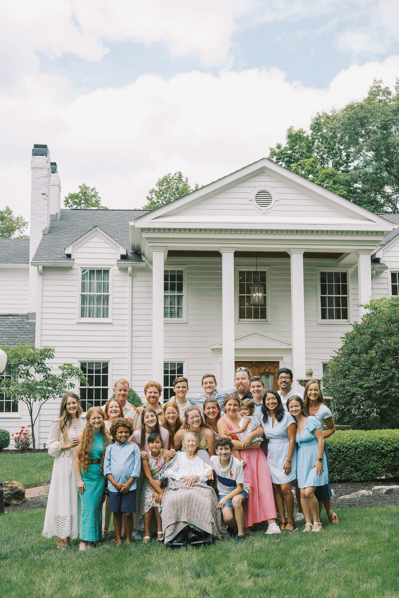 group family photo in front of white house