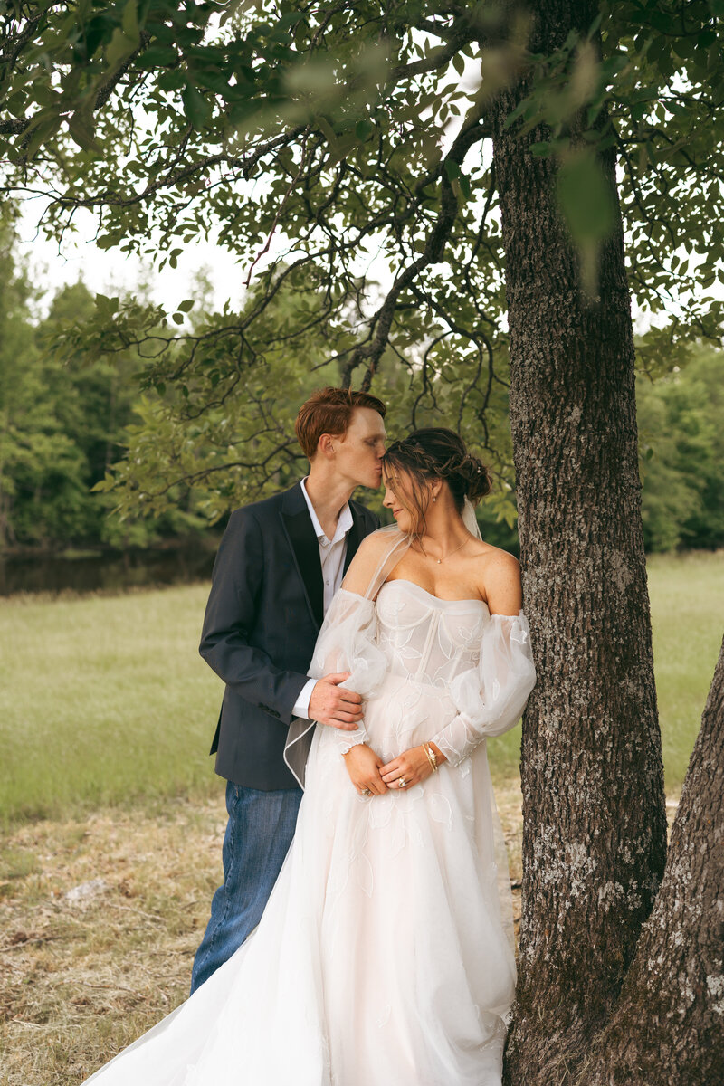 Bride and groom sharing a quiet moment under a tree at their Nashville, TN wedding—intimate, editorial portrait with natural, story-driven charm.