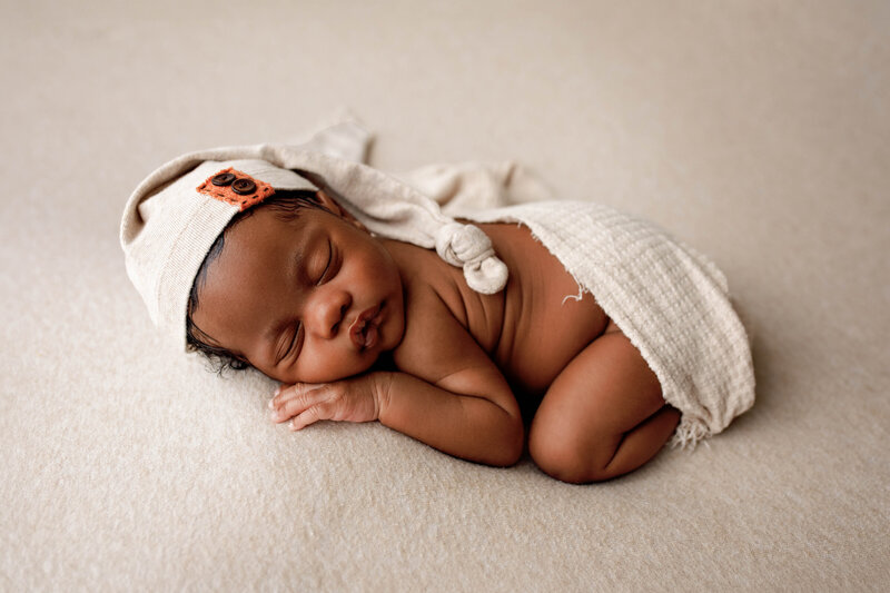 Newborn Baby Boy on Oatmeal Blanket with wrap and sleepy cap in Decatur, TX
