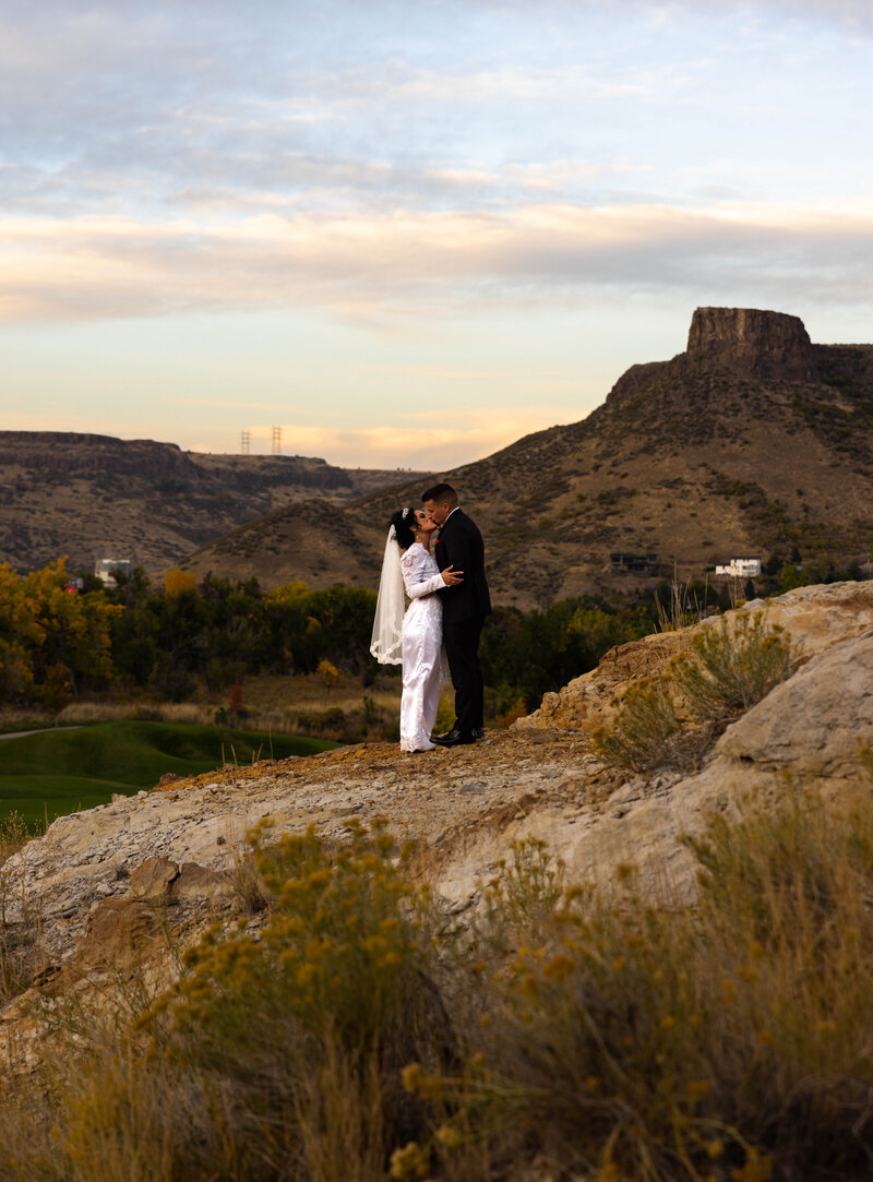 Couple Looking at each other in a field in the Utah Mountains during Fall colors