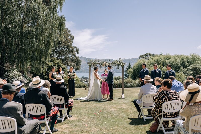 a wedding ceremony in progress in the sun on the lawn at mt vernon lodge