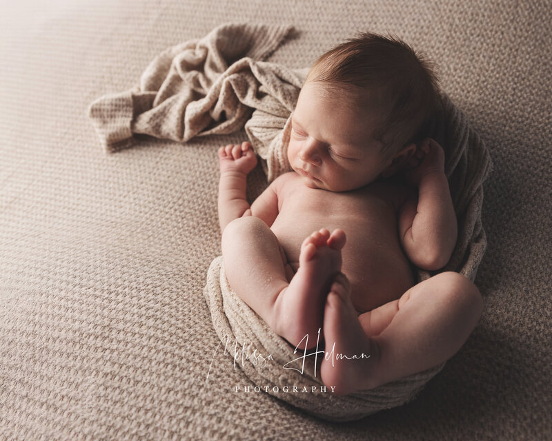 Newborn baby sleeping with feet up for newborn portraits in Pittsburgh pa.