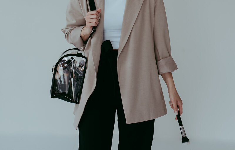 Makeup artist holding makeup brushes