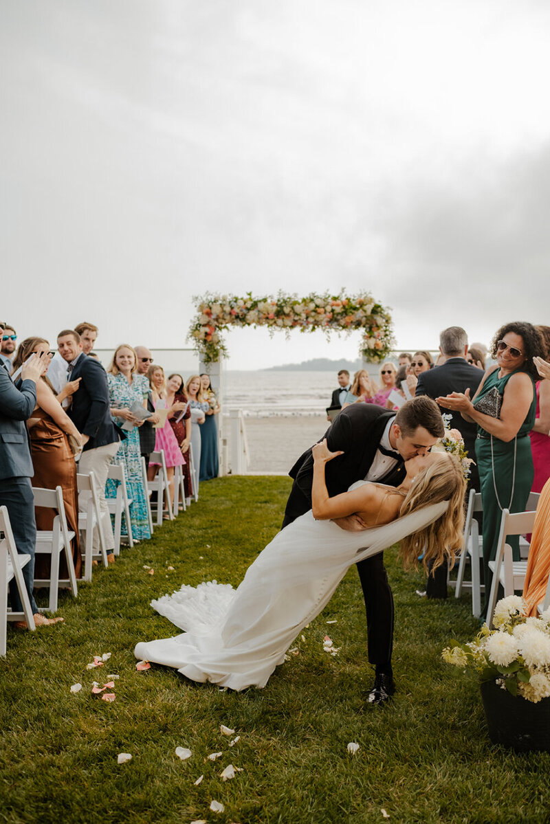 groom-kissing-bride-in-aisle