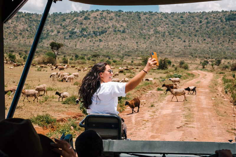 Woman taking selfie on African safari