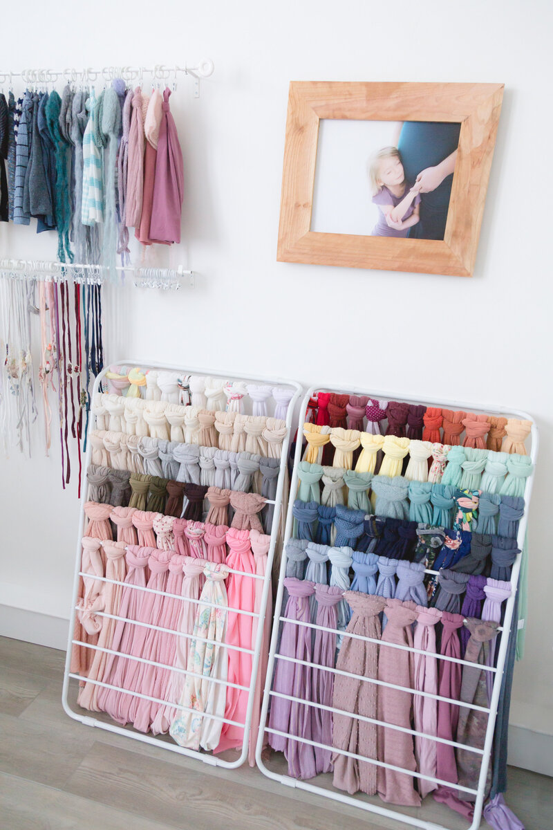 A beautiful display of colorful wraps for babies.