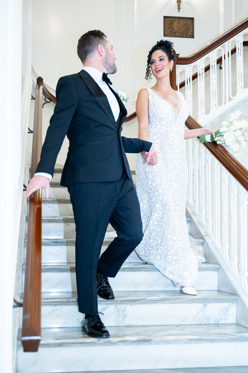 bride and groom walking down stairs