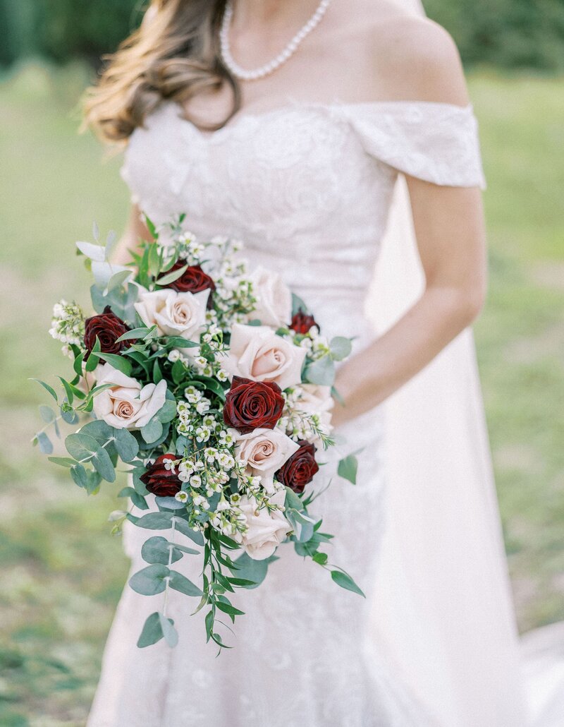 bride-with-bouquet-flowers-her-hands-walks-through-park-cropped-faceless