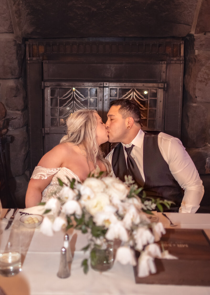 Couple kissing at the table at Silcox Hut, Timberline Lodge.