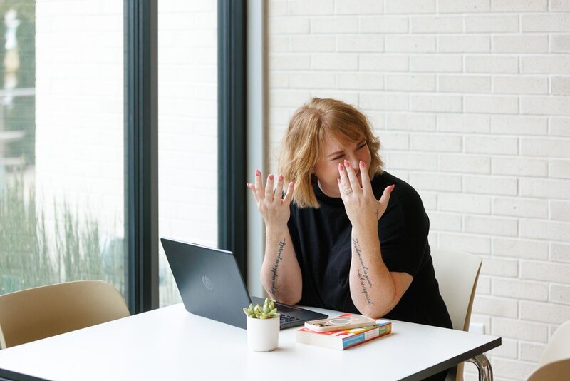 Ashley Ebert smiles while teaching a session to grow your wedding business