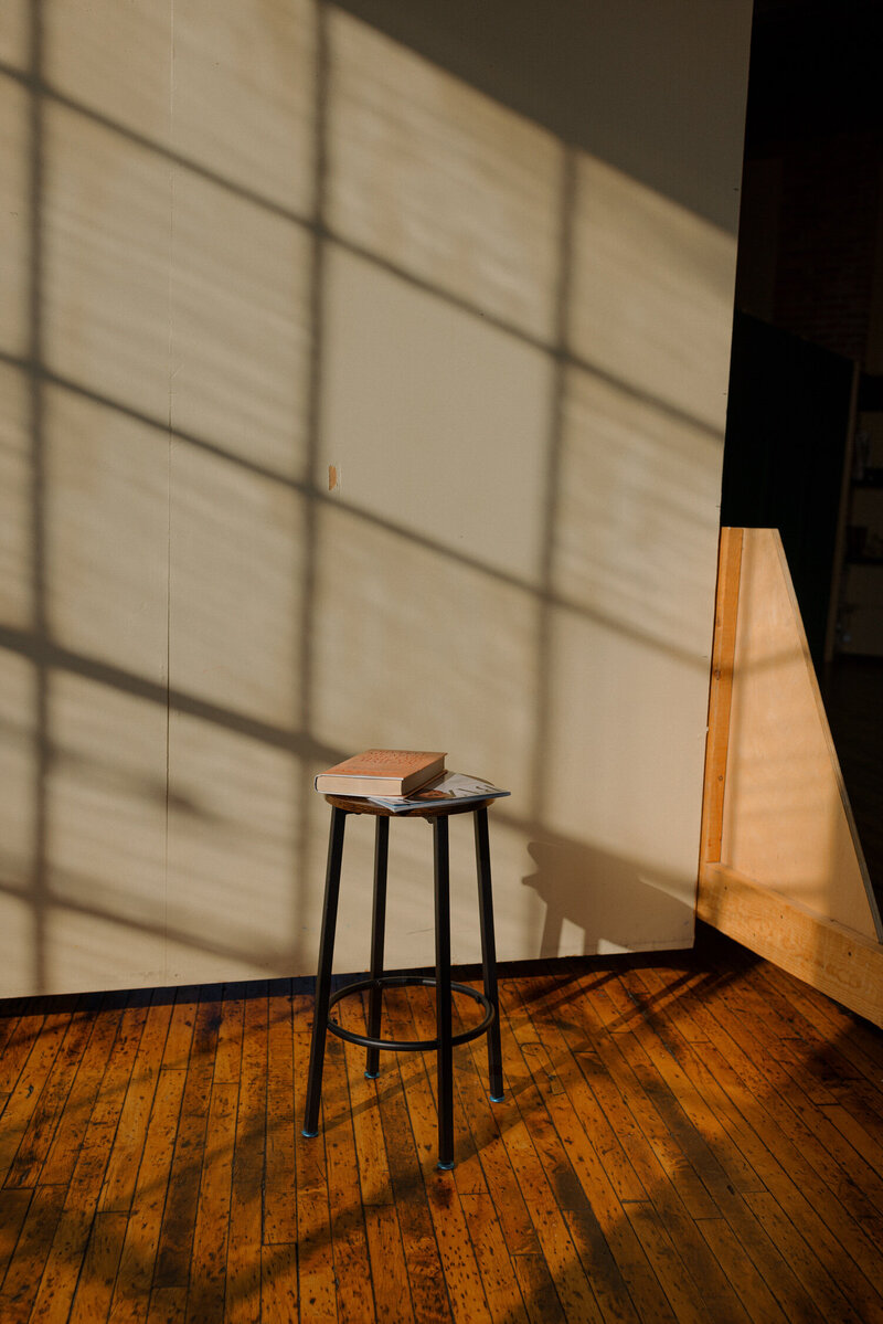 book on top of a stool in an empty room