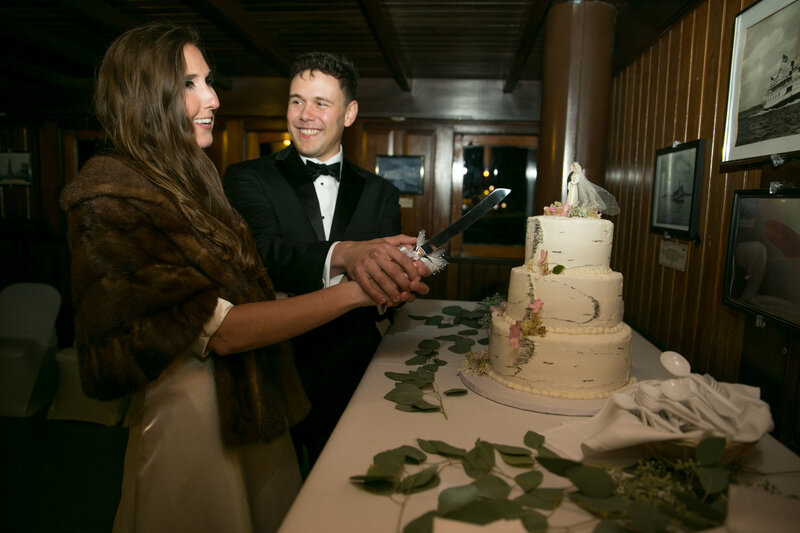 Bride and groom cutting cake at reception | Wedding Photography