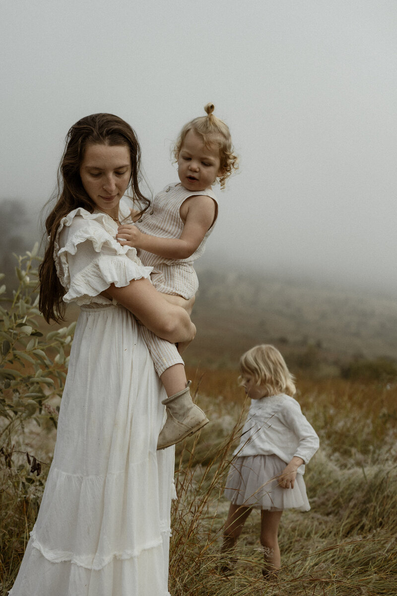 Motherhood photo, mummy and me, carrying her two kids