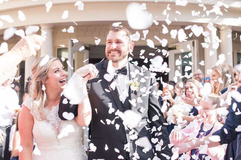 a bride and groom being showered with confetti at the sterling hotel in downtown sacramento