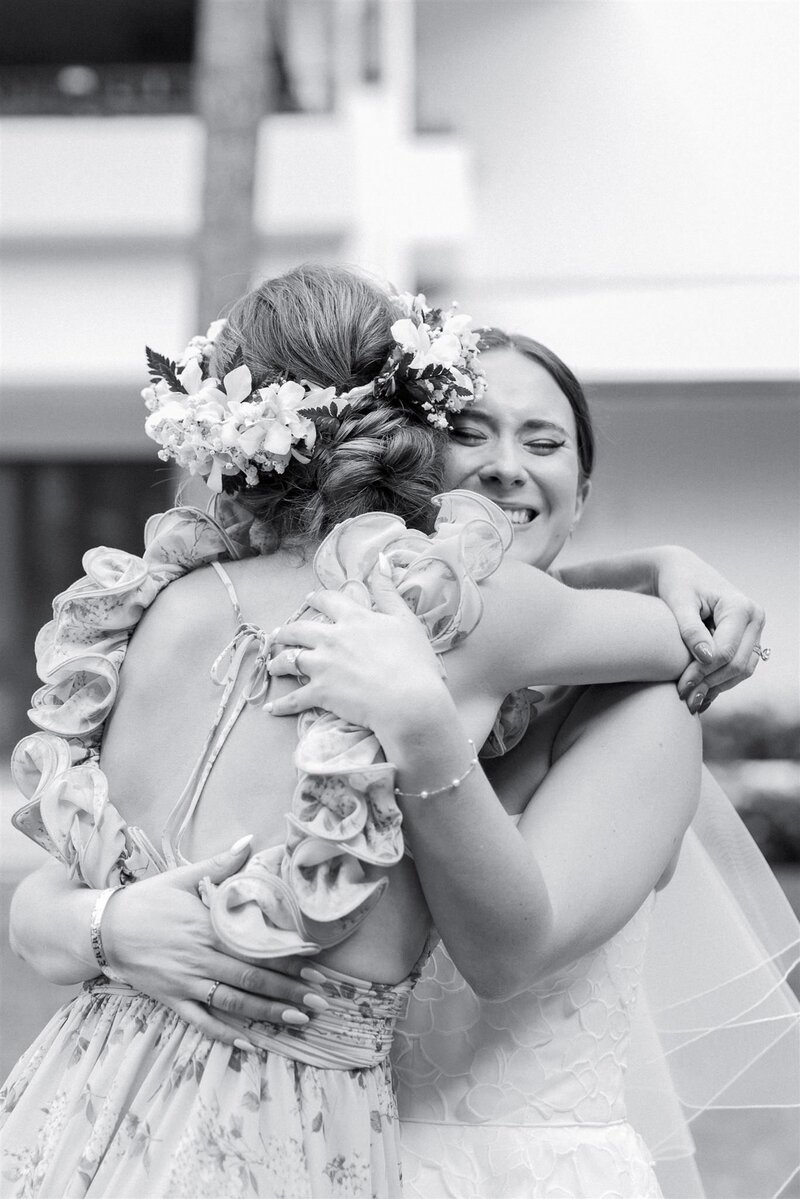 A newlywed hugging a wedding guests and crying 