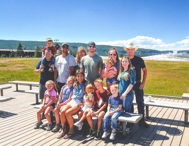 Family of Spokane interior designer Stephanie Sarro in front of a nature backdrop of green hills and mountains.