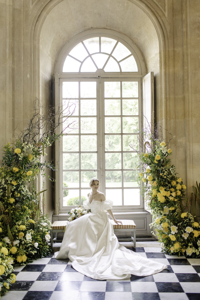 Bride in front of a window at Chateau de Champlatreux