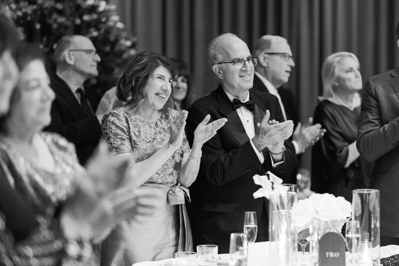 Candid photo of parents watching their children dance at their wedding at the Book Tower Detroit.
