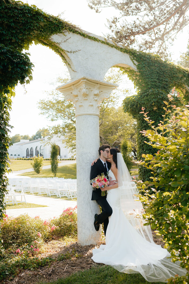 a bride and groom kiss near the alter during their wedding portraits after their ceremony photographed by alabama and washington wedding photographer sarah mismash