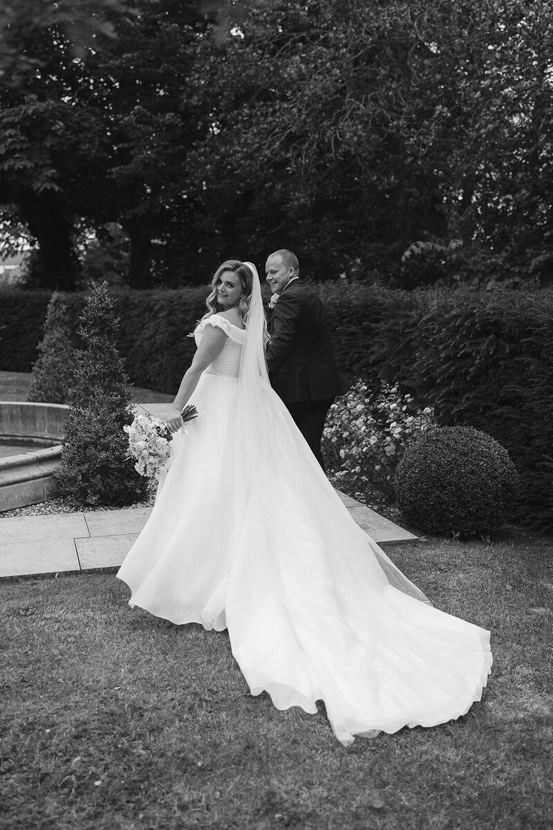 bride-groom-walking-black-and-white-photo-looking-back