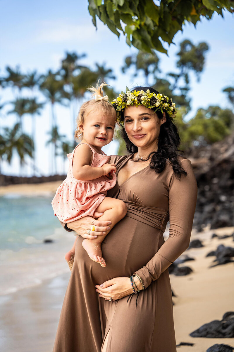 Mom holding her little girl on the beach taken by one of the best Big Island photographers