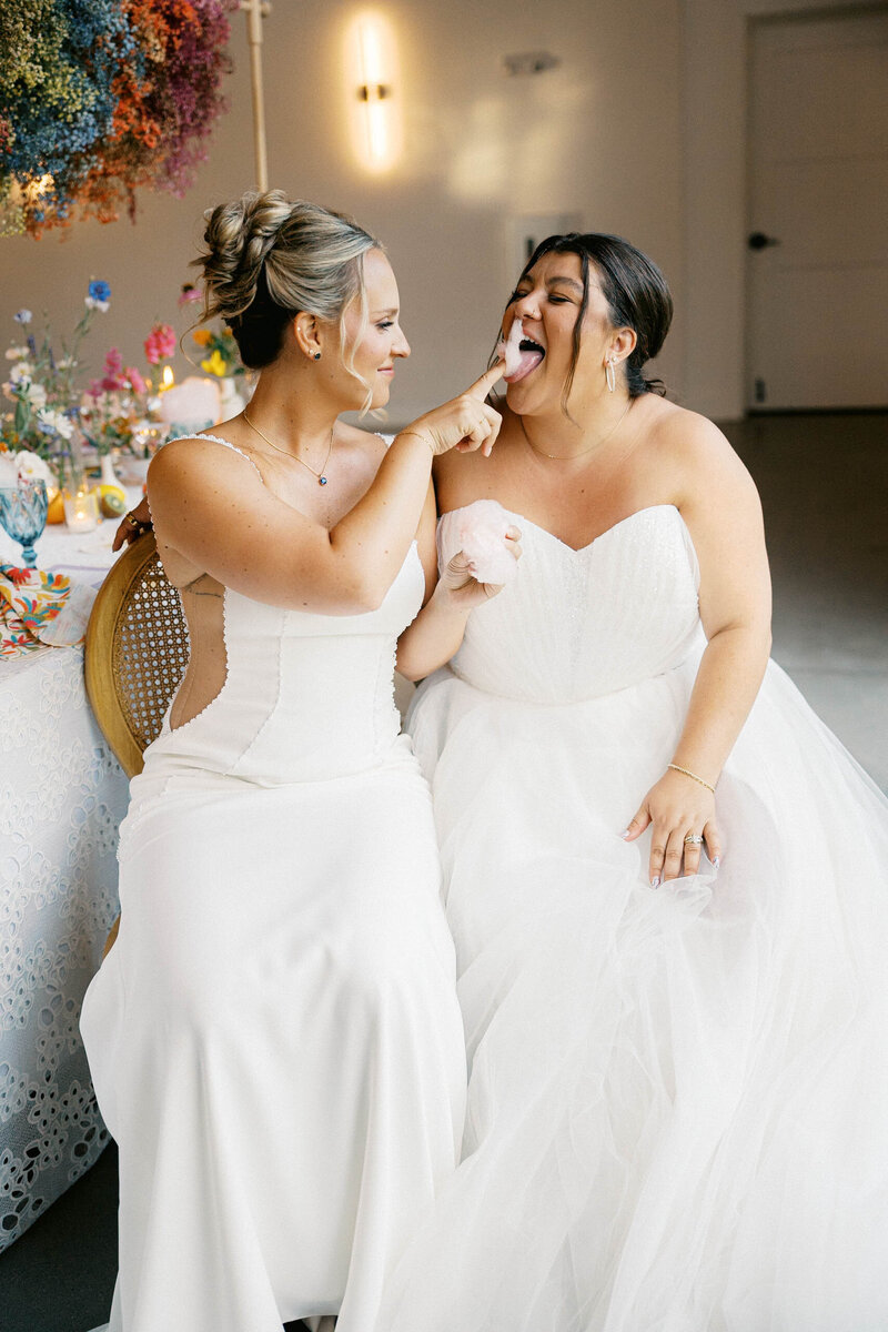 brides feed eachother cotton candy at reception taken by boston documentary wedding photographer