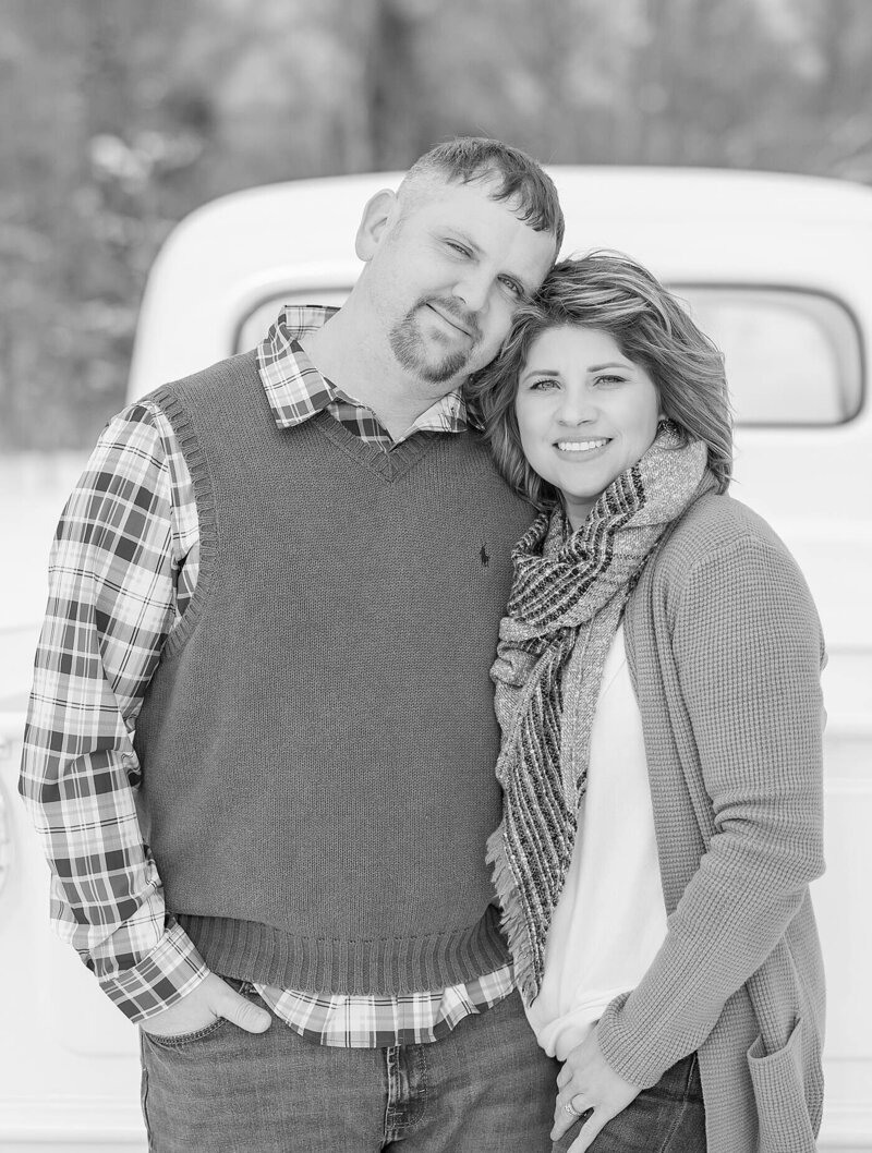 Couple smiling by a vintage truck outdoors for North East, PA, couple’s photos.