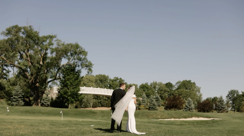 bride and groom walking on golf course