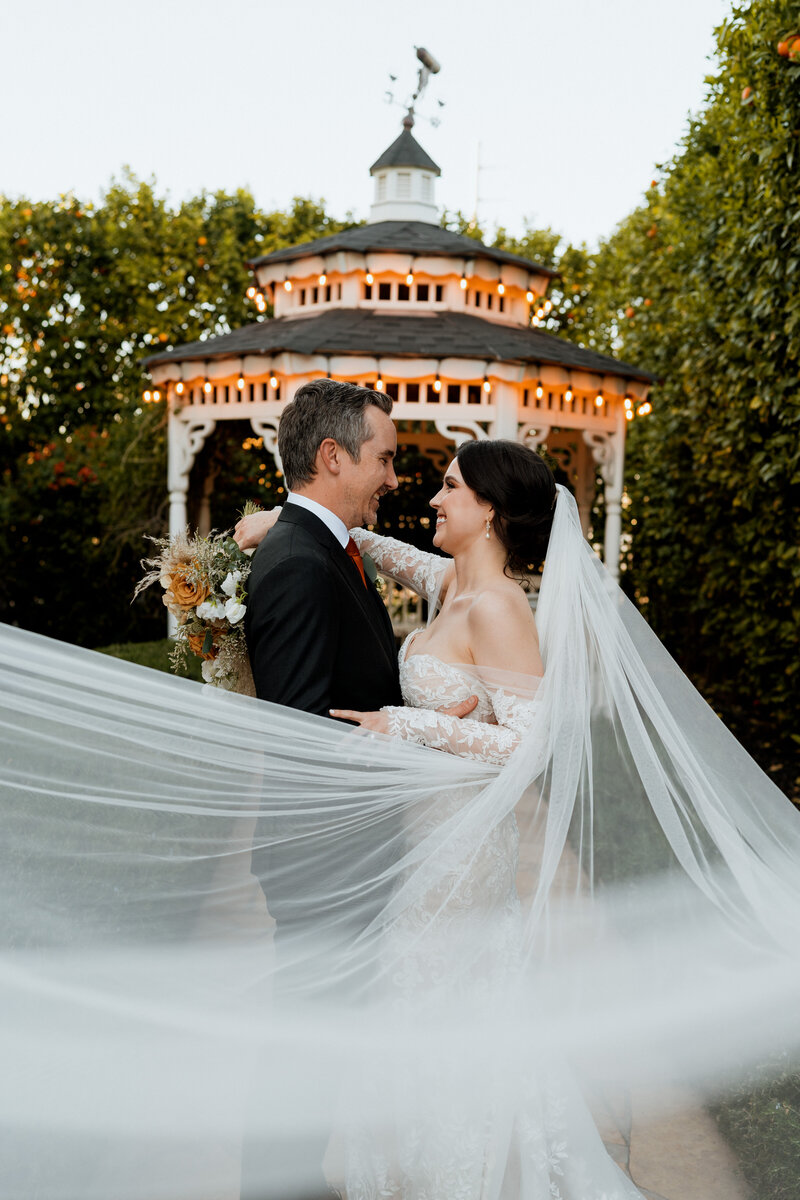 A wedding couple holding hands and walking together.