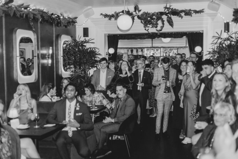 A view of a reception as guests listen to wedding speeches in Brisbane City at Wooloongabba