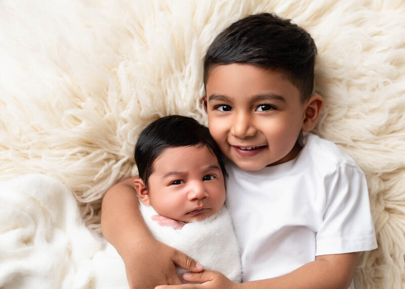 sibling-portrait-older-child-holding-newborn-baby-6