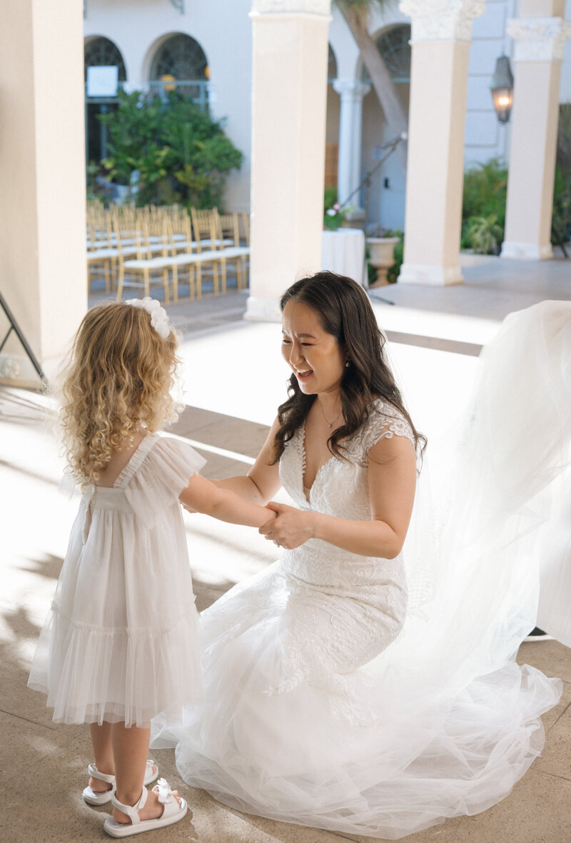 bride hugging flower girl 