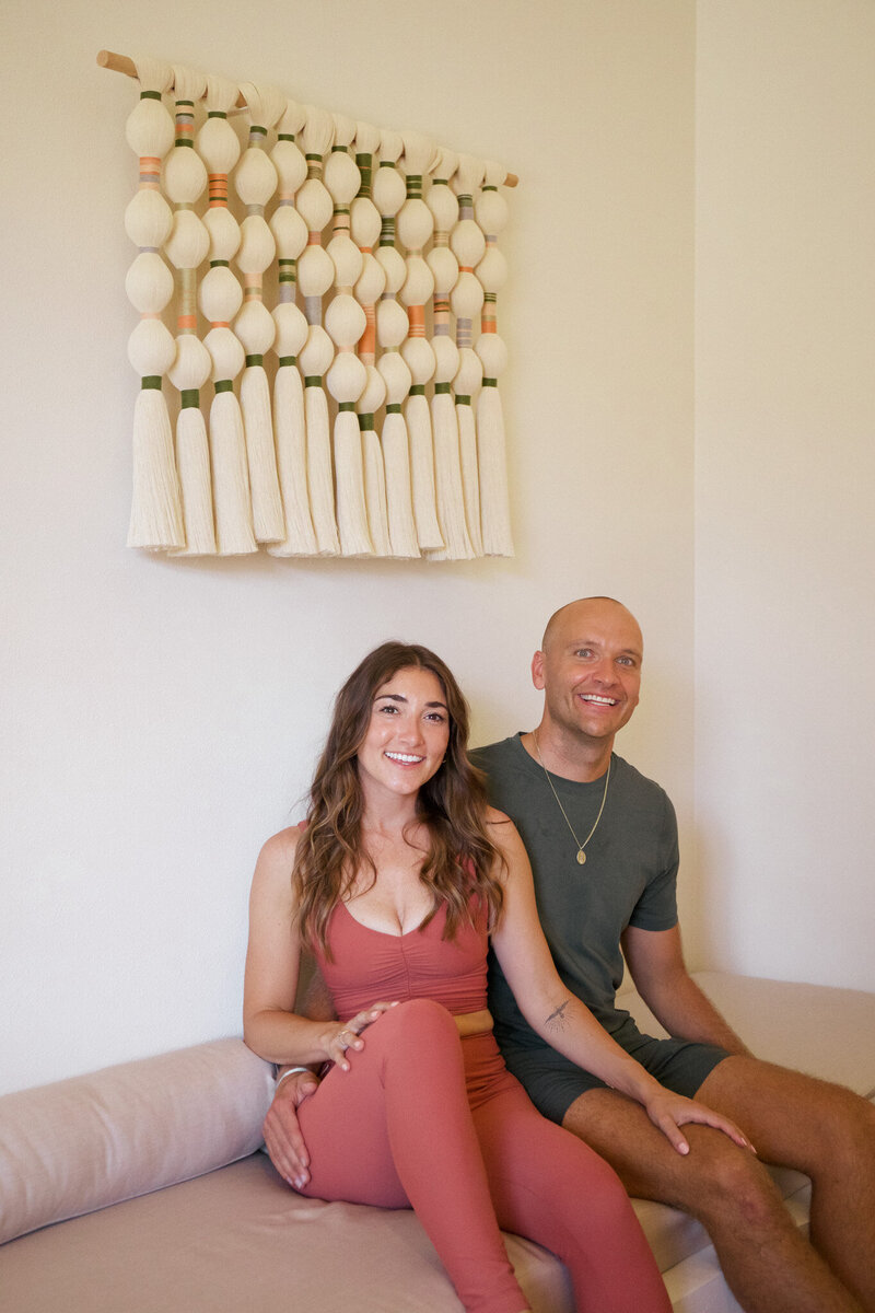 Photo of the co-founders of Soul Plunge sitting together, husband and wife team, Mia and Matt Heck.