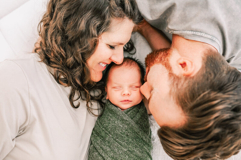Springfield MO newborn photography of newborn baby sleeping between parents