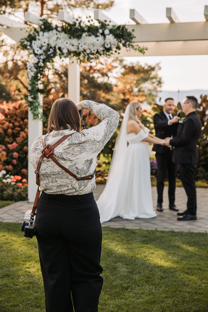 Toronto wedding photographer, Shannon, capturing a couple at their outdoor wedding ceremony