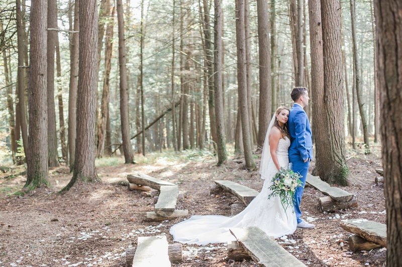 Groom-with-bride-holding-fuschia-bouquet-in-desert-wedding-by-the-Jepsons