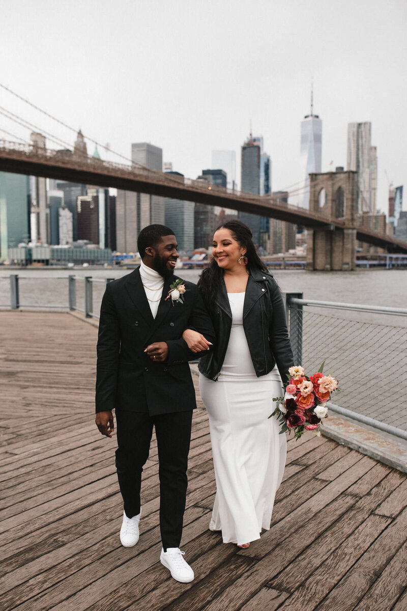 NYC elopement couple in central park kissing with flowers and san remo